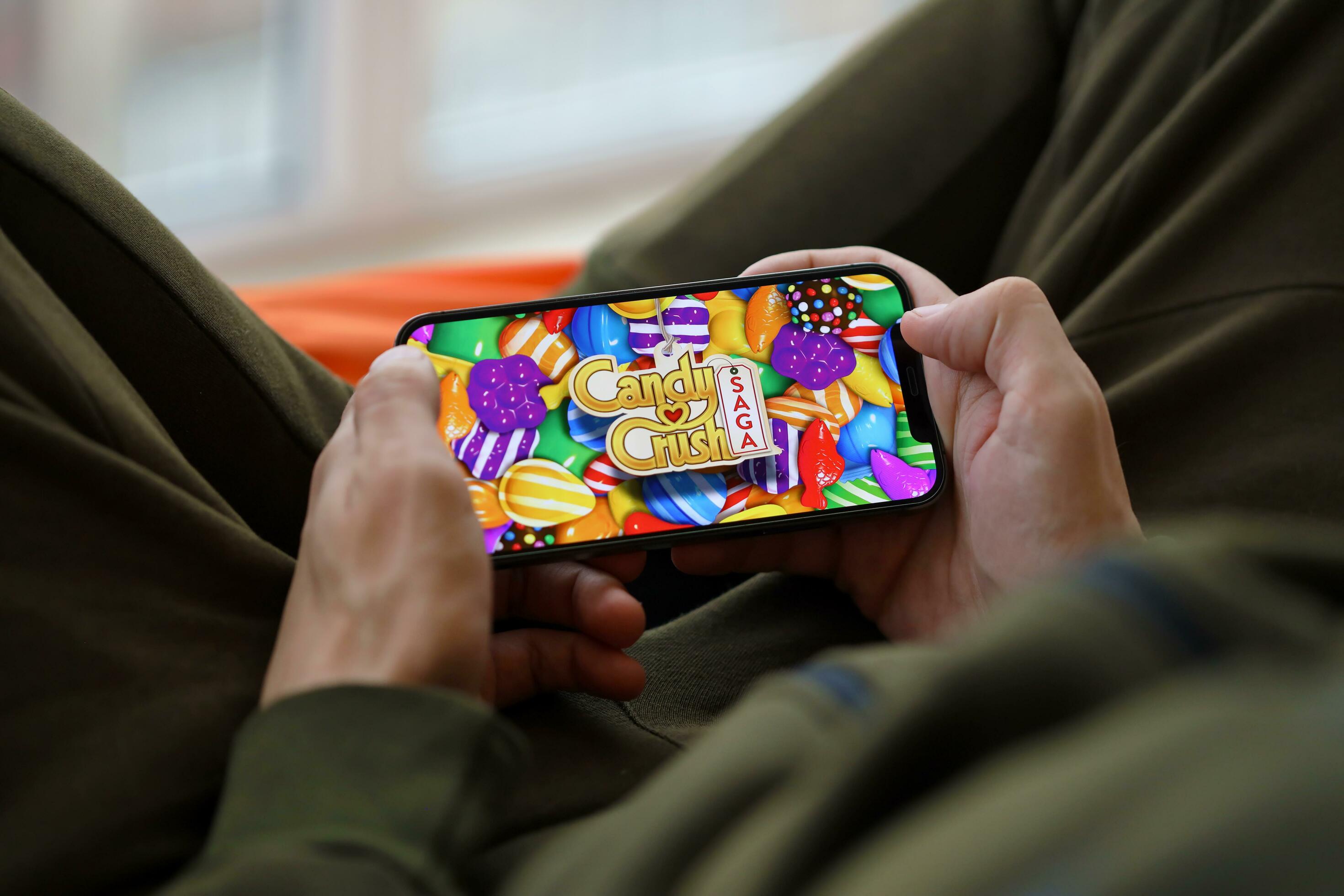 A person playing Candy Crush Saga on a smartphone
