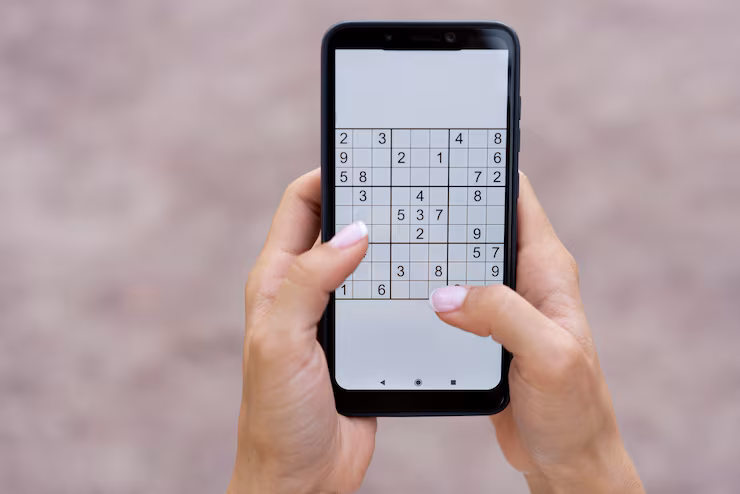 A person playing soduku on a smart phone