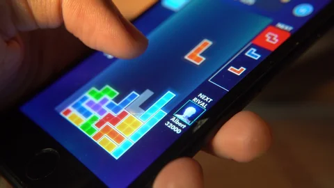A smartphone screen showing a game of Tetris in progress